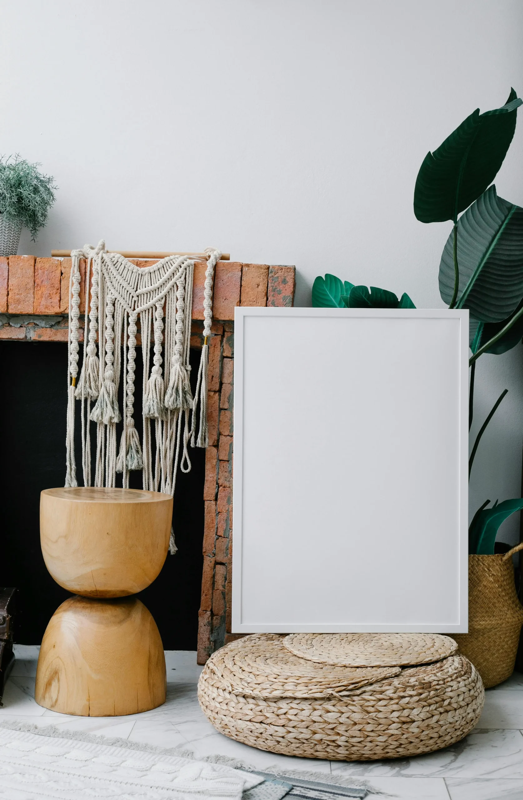 Boho-style DIY home decor with macrame, potted plants, and an empty photo frame on the floor.